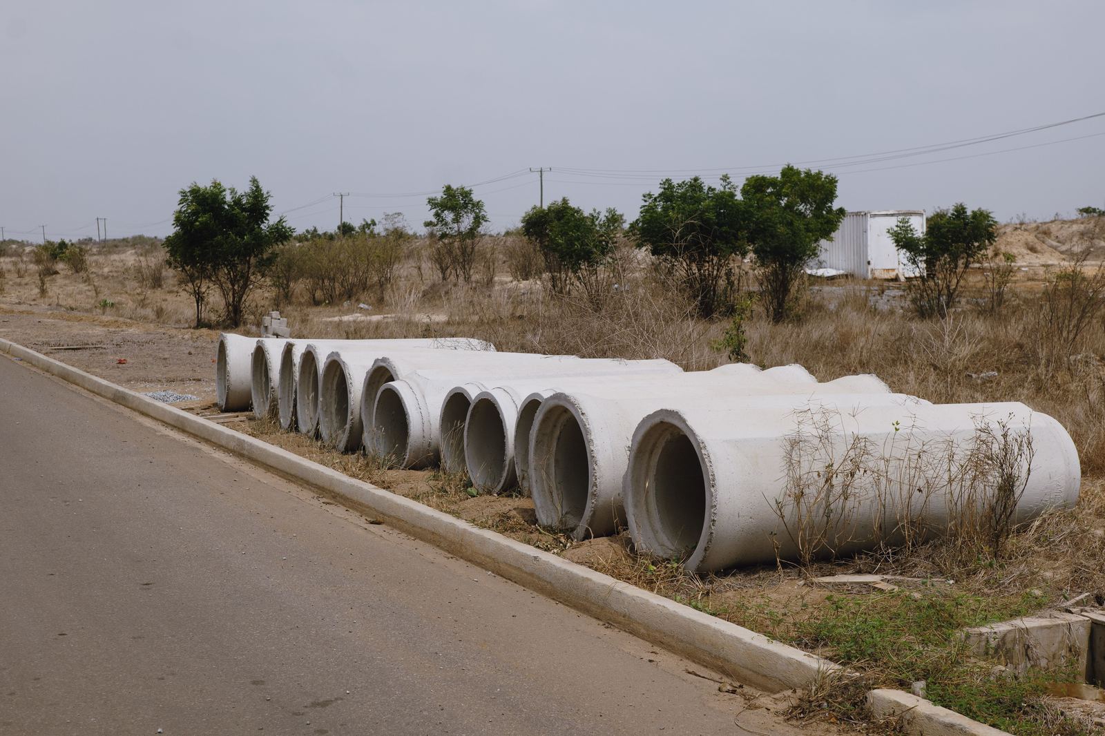 Stacked concrete pipes staged for a construction site